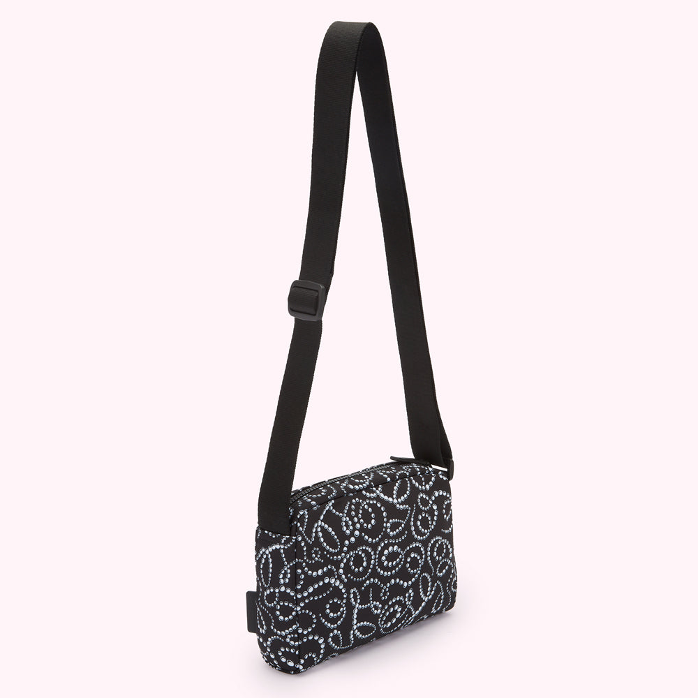 Black crossbody bag with a light-grey patterned design.
