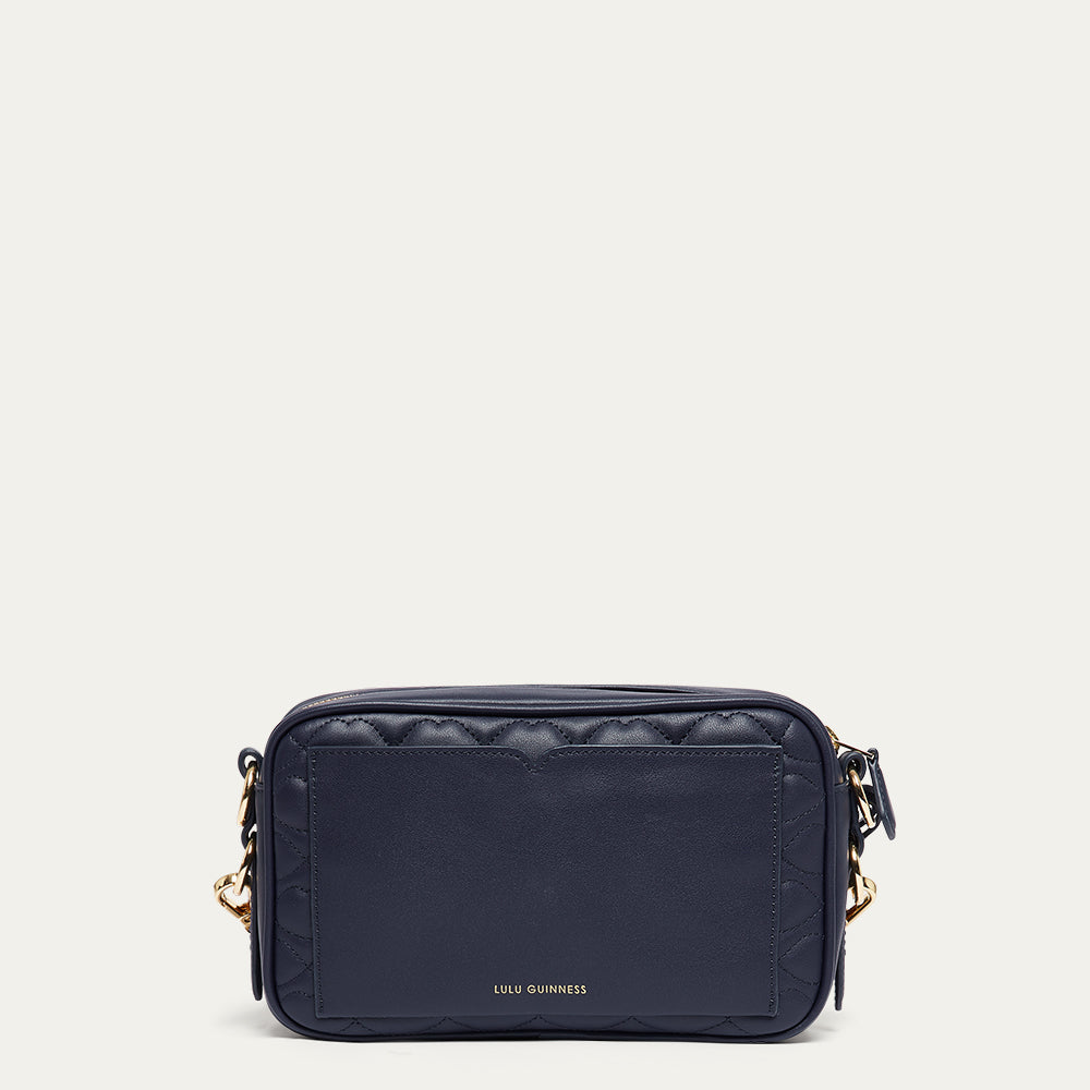 Navy blue leather crossbody bag with gold accents on a white background