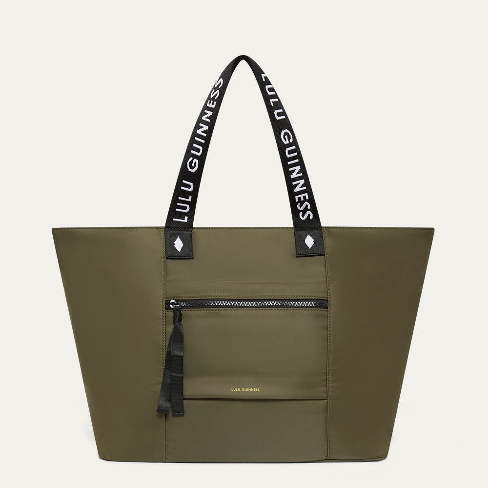 Green tote bag with black handles featuring 'Lulu Guinness' on a white background
