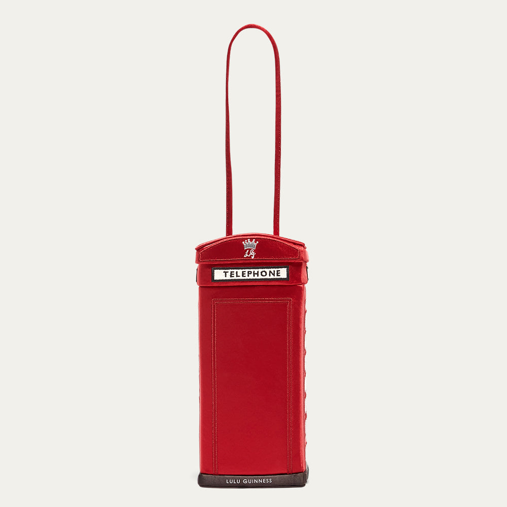 Red phone box shaped bag with a strap on a white background