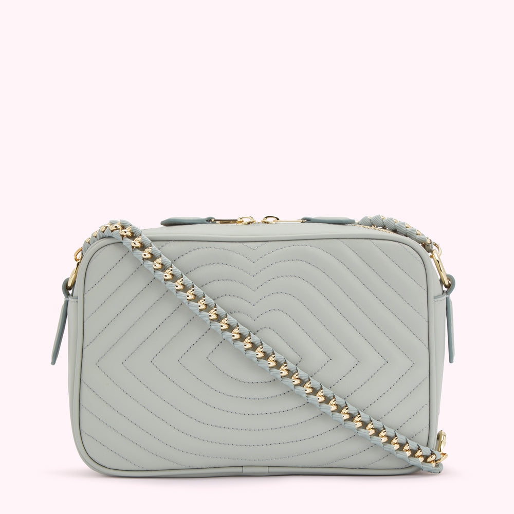 Light blue quilted crossbody bag with gold chain strap.
