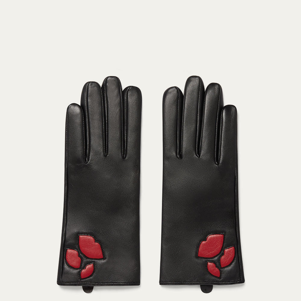 Pair of black gloves with red lip designs on a light gray background