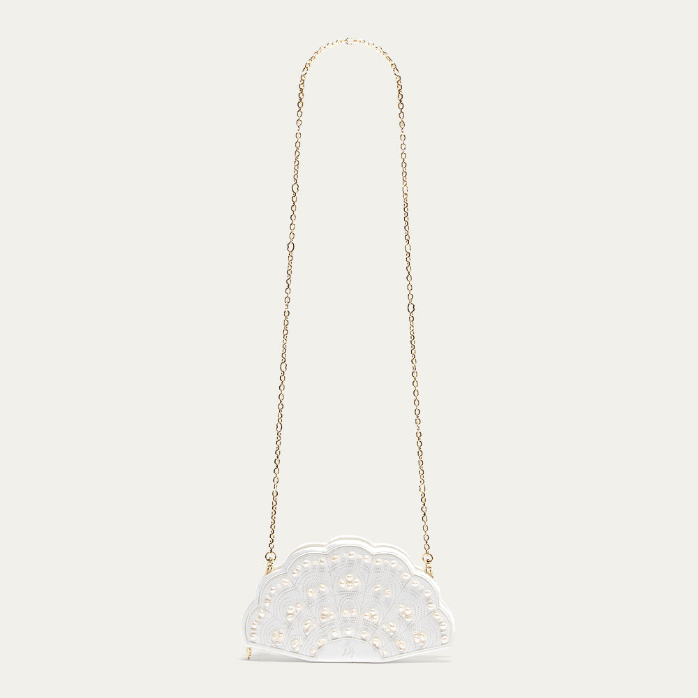 A white satin fan-shaped handbag with gold chain strap on a light gray background