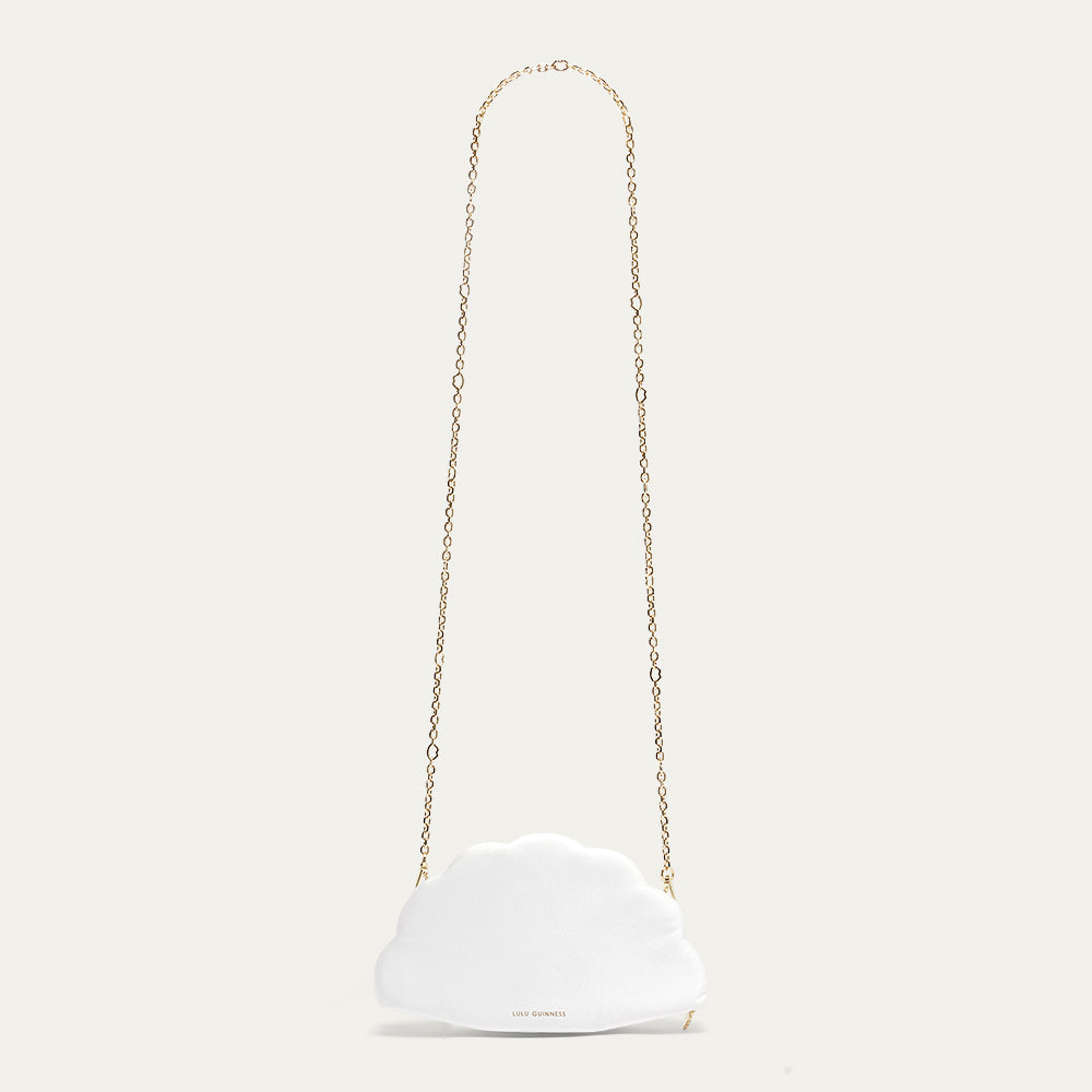 White satin fan shaped handbag with a gold chain strap on a light beige background
