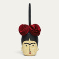 Handbag designed like Frida Khalo with red floral accents on a light gray background