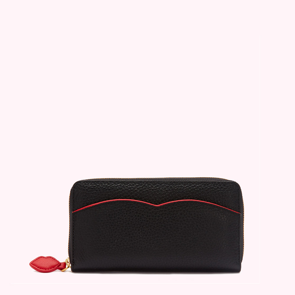 Black leather zip-around wallet with red lip-shaped detail on the zipper pull.
