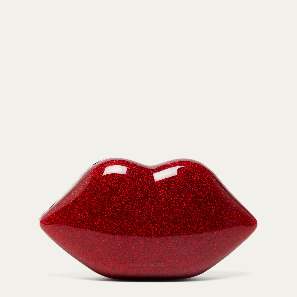 Red glittery lip-shaped clutch bag on a light gray background