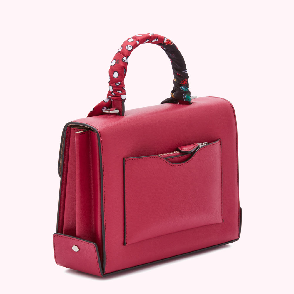 Red leather satchel with a patterned scarf handle and front zipper pocket.
