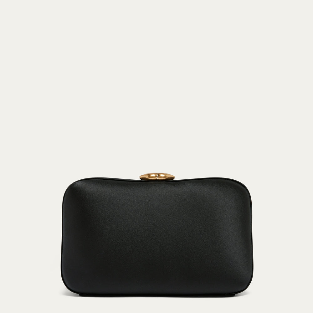 Black satin clutch bag with a gold lip clasp on a light gray background