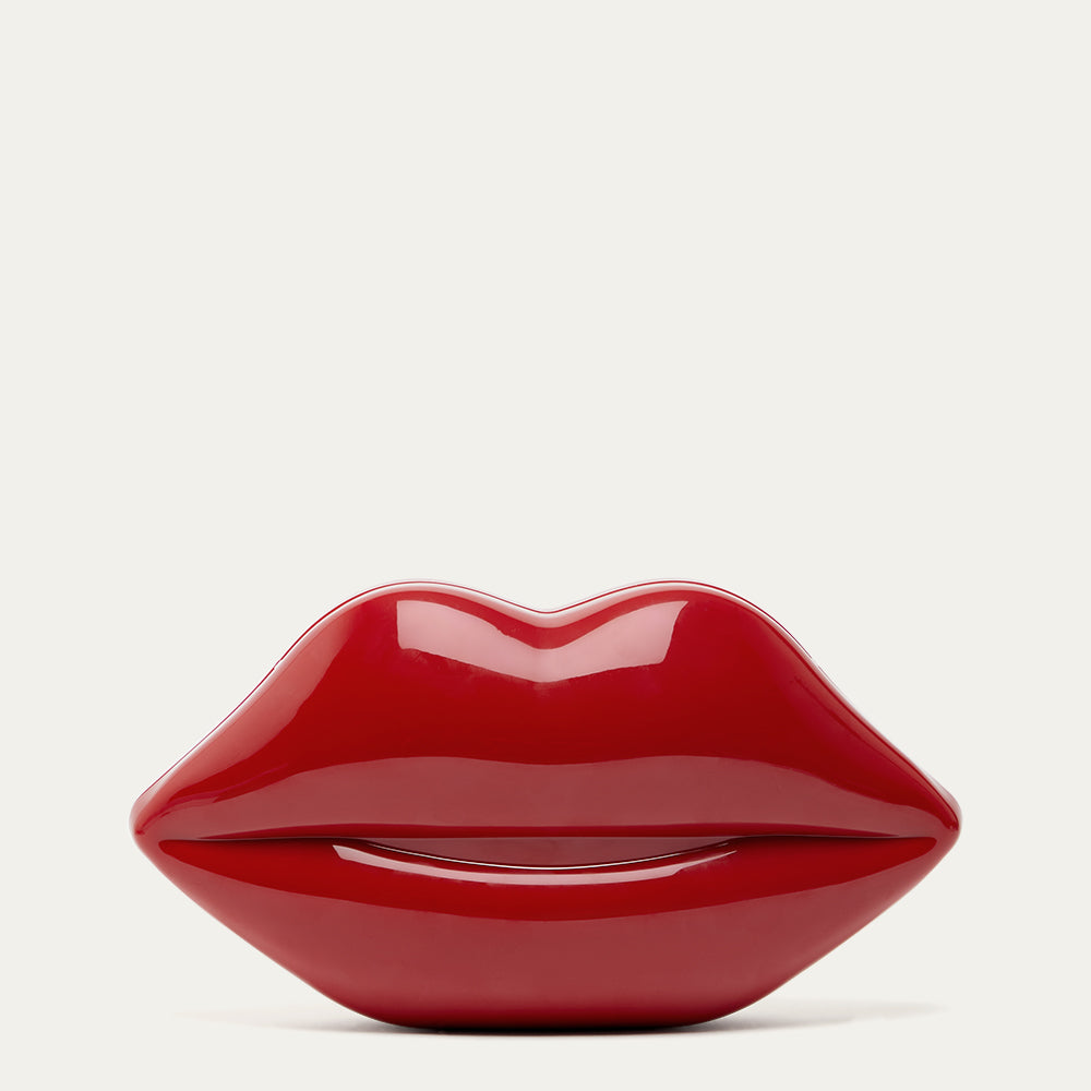 Red lip-shaped clutch on a light gray background