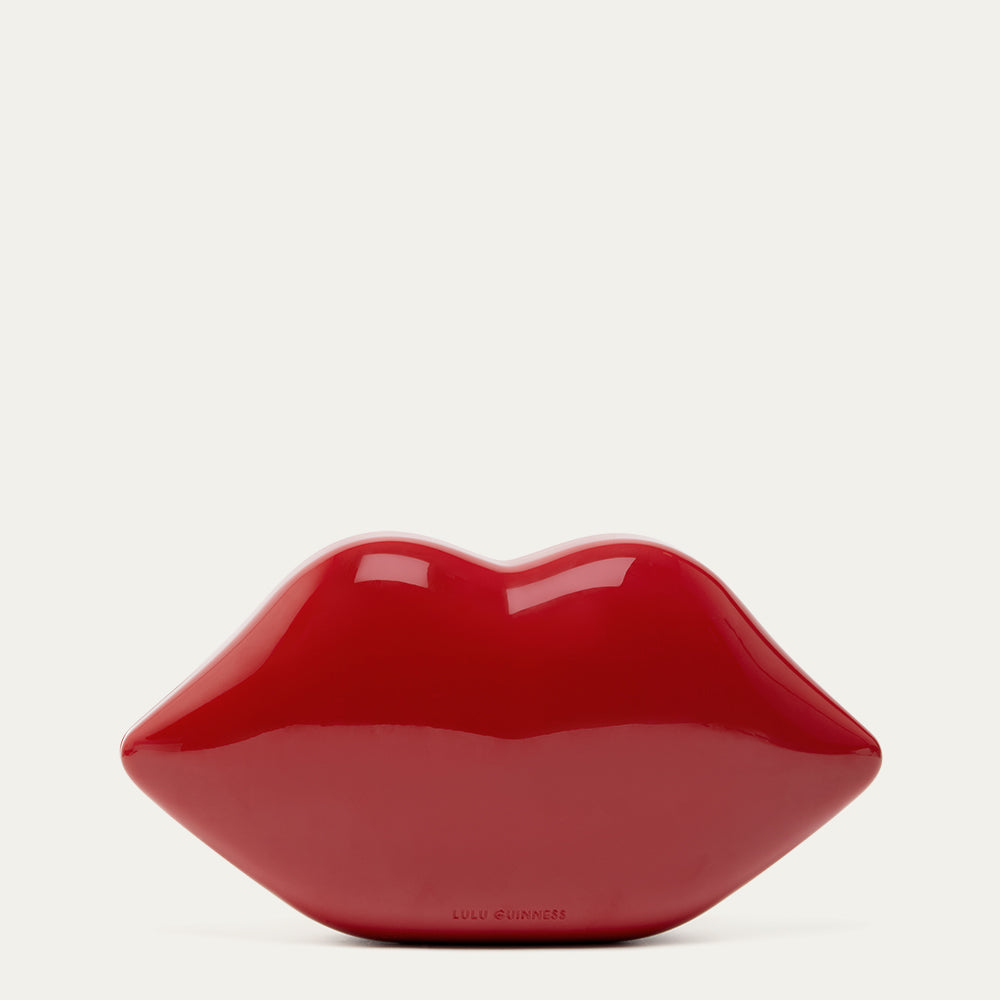 Red lip-shaped clutch on a light gray background