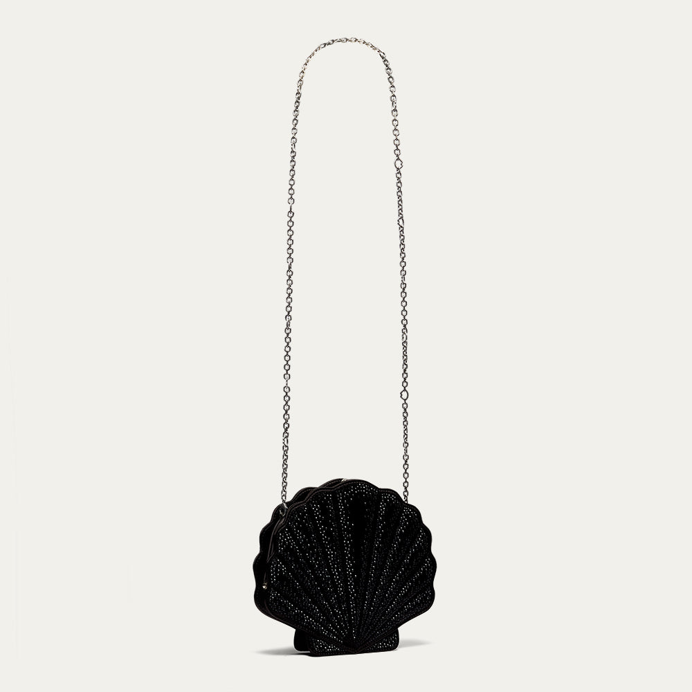 Black shell-shaped handbag with a chain strap on a light gray background