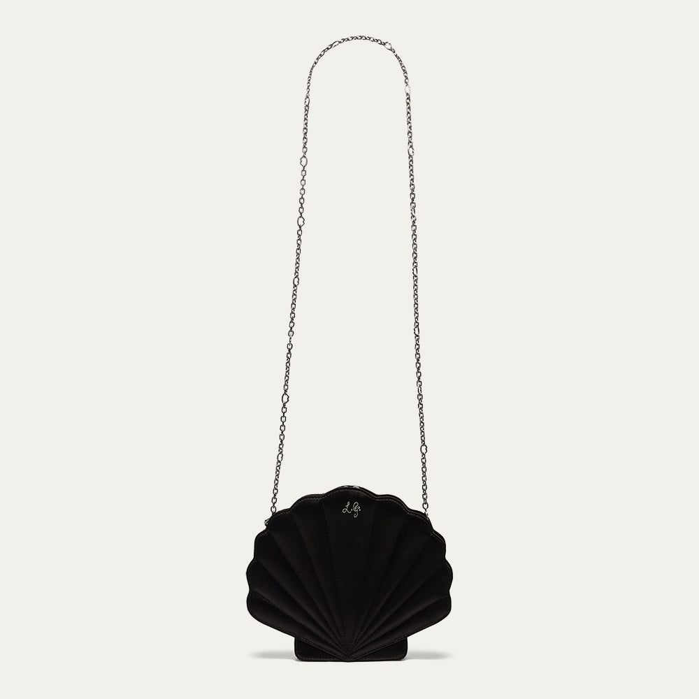 Black shell-shaped handbag with a chain strap on a light gray background