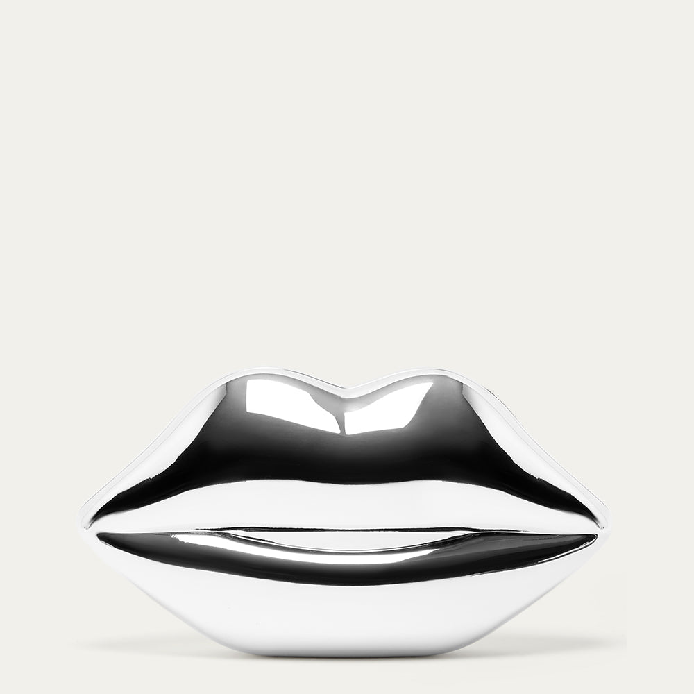 Metallic silver lip-shaped clutch bag on a light gray background