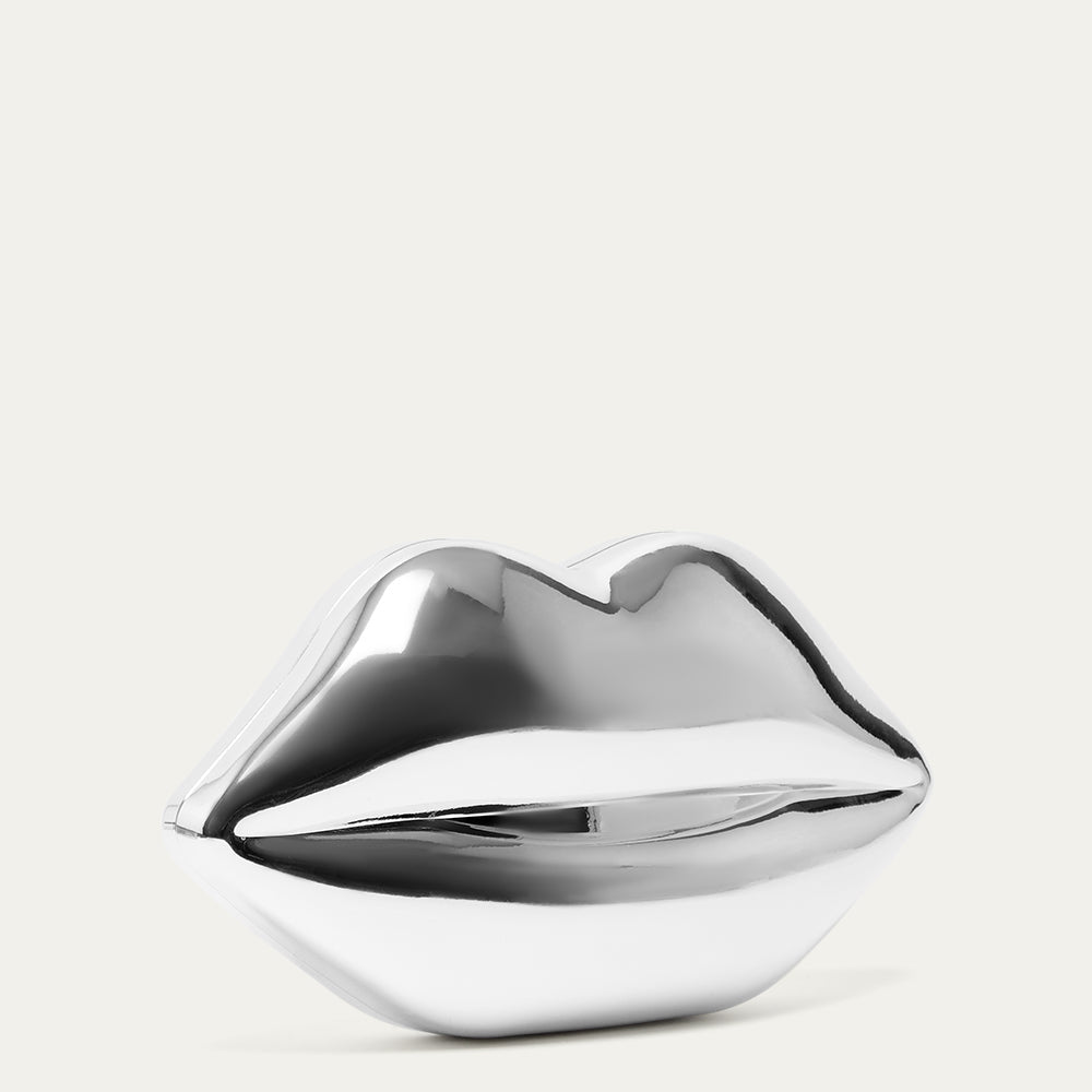 Metallic silver lip-shaped clutch bag on a light gray background