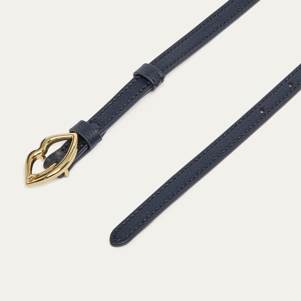 Navy leather belt with a gold lip-shaped buckle on a light gray background
