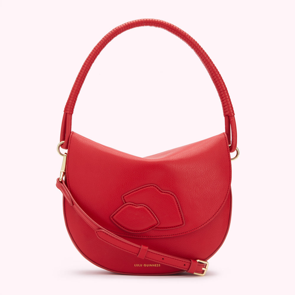 Red Lulu Guinness crescent-shaped handbag with lips detail.
