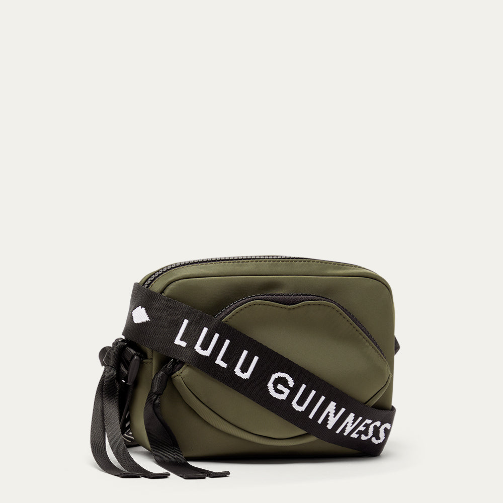 Green bag with a black strap featuring 'Lulu Guinness' on a white background