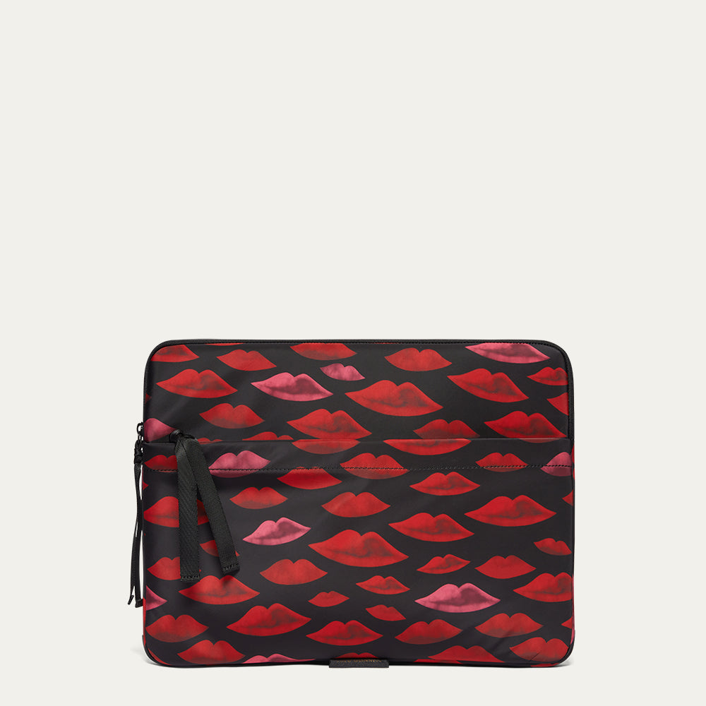 Laptop case with red and pink lip pattern on a beige background