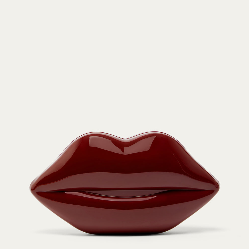 Burgundy red lip-shaped clutch bag on a light gray background