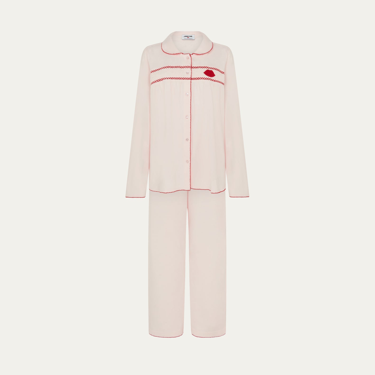 Pink pajama set with red stitching on a white background