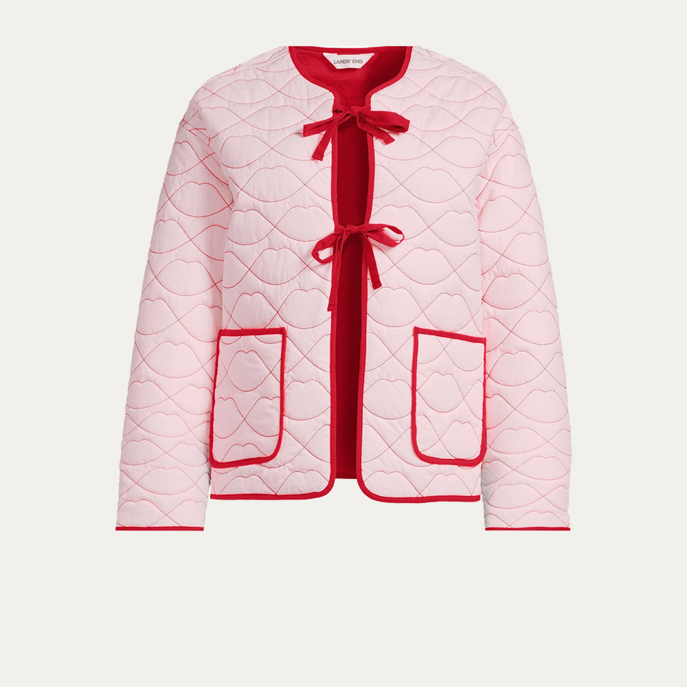Pink quilted jacket with red accents, lip shaped quilting and red ties on a white background