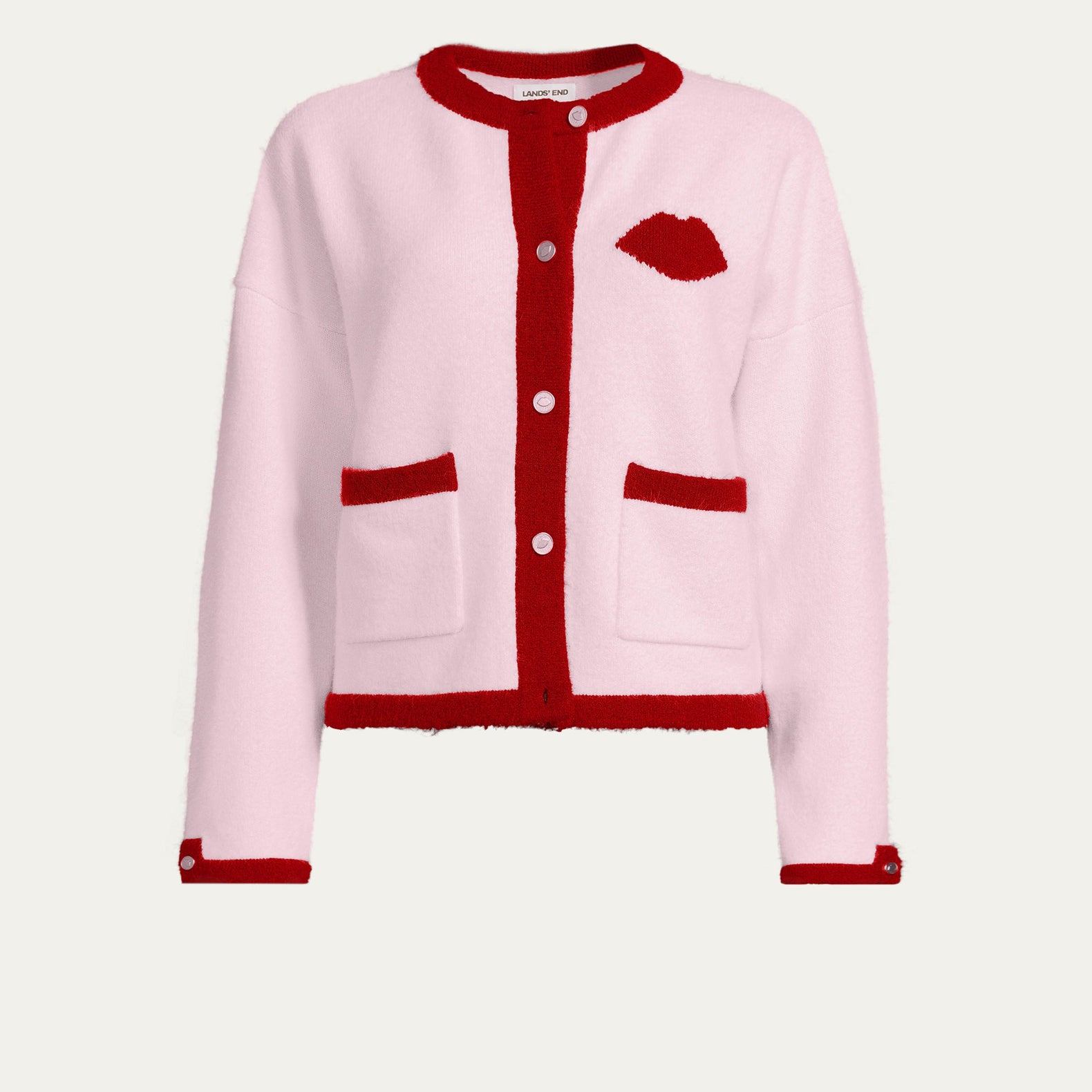 Pink cardigan with red trim on a white background
