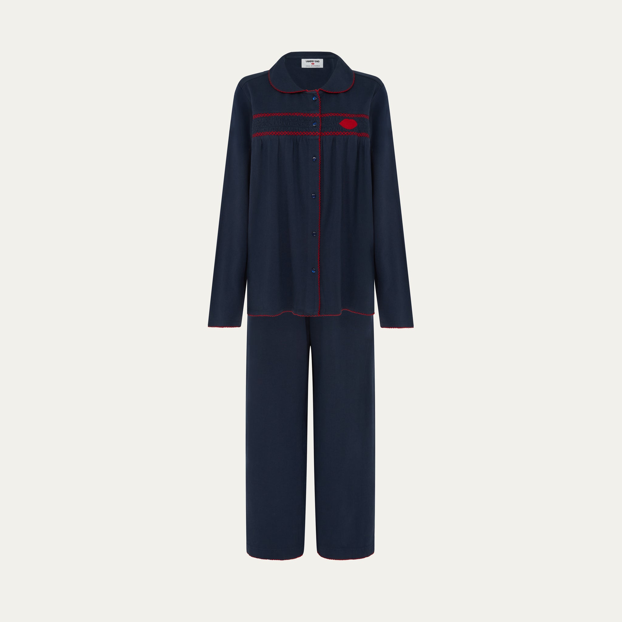 Navy pajama set with red accents on a light gray background