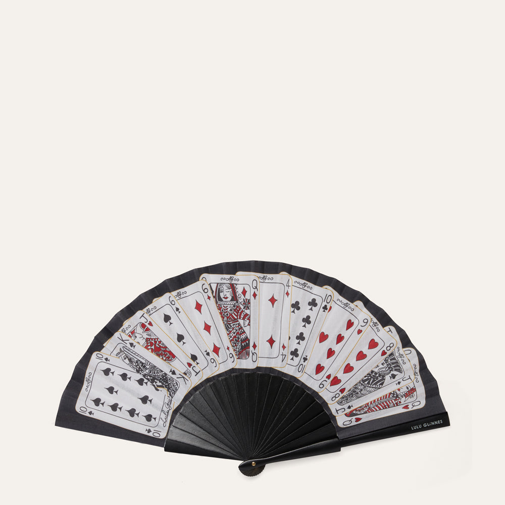 Black fan with playing card designs on a white background