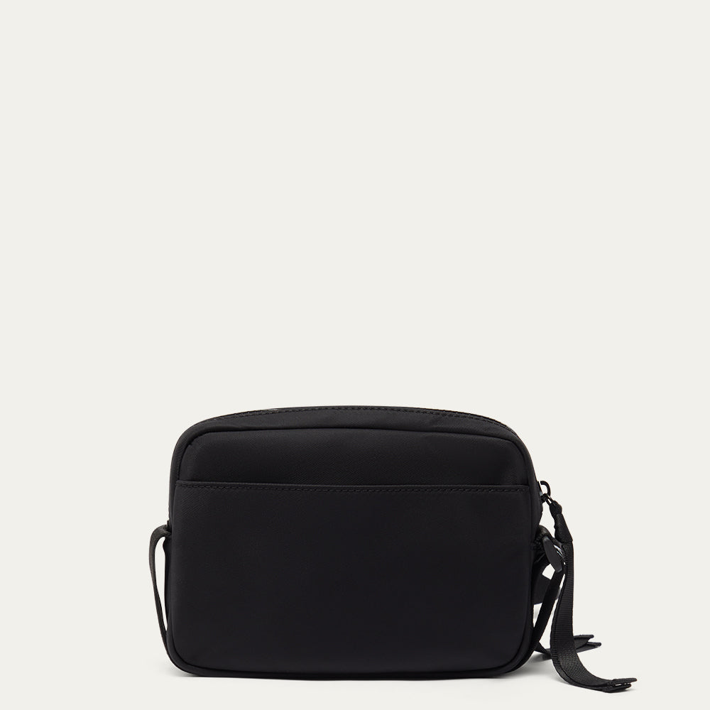 Black crossbody bag on a light gray background