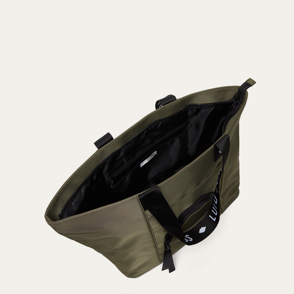 Green bag with black interior on a light gray background