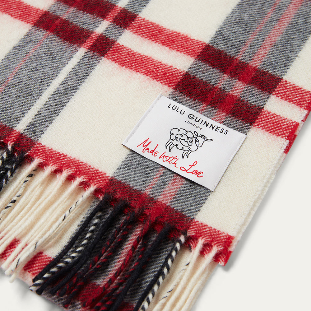 Plaid scarf with Lulu Guinness label on a white background