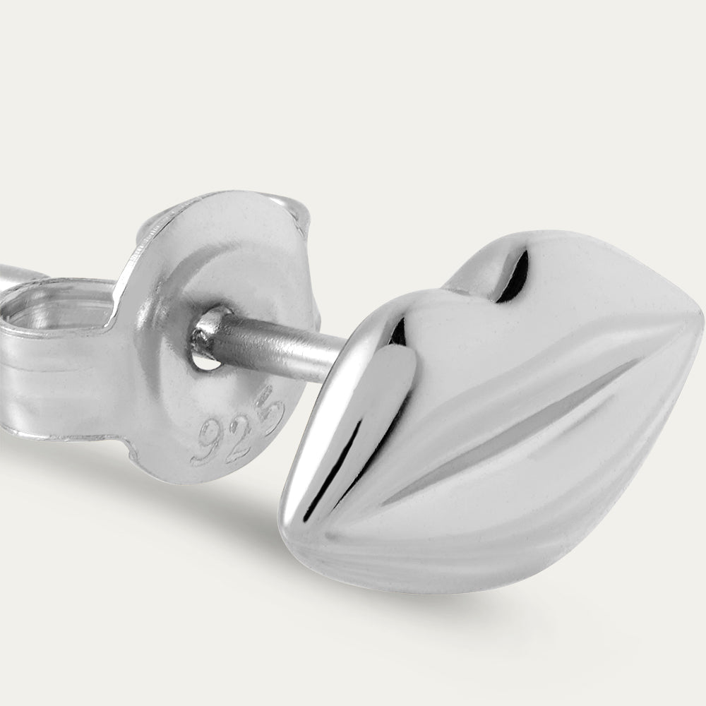 Silver earring on a white background
