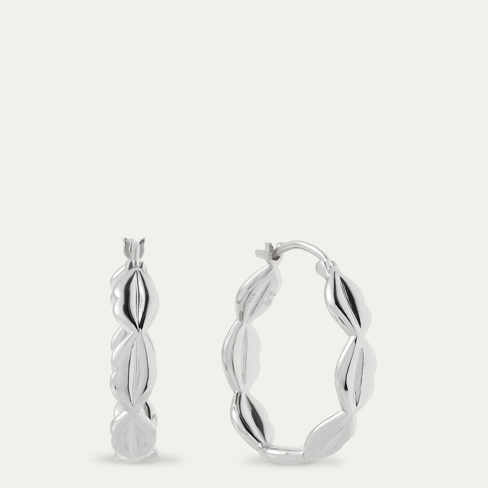 Silver hoop earrings on a light gray background