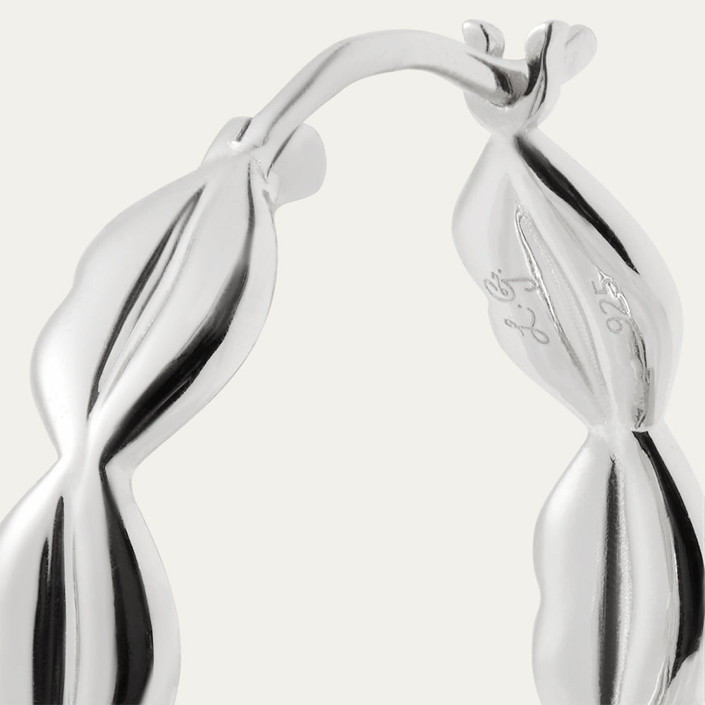Silver hoop earrings on a light gray background