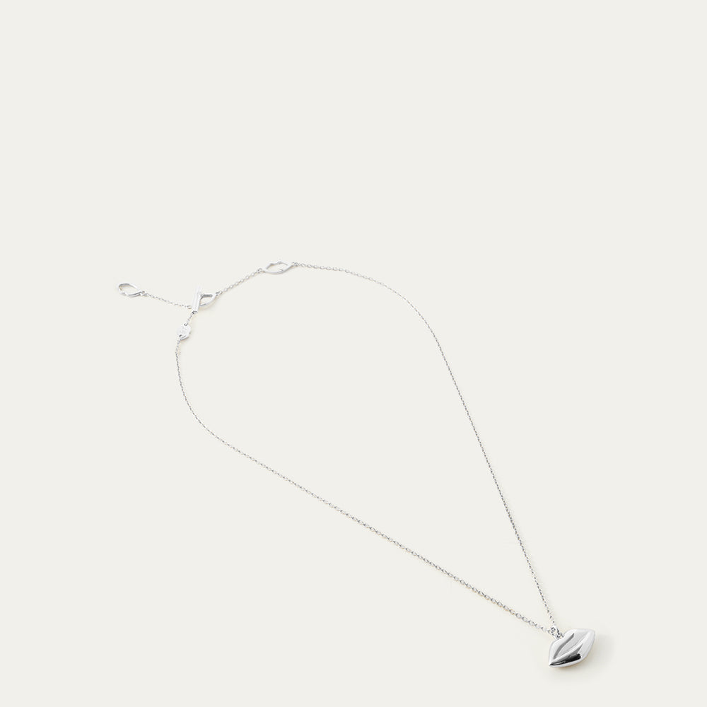Silver necklace with a lip-shaped pendant on a white background