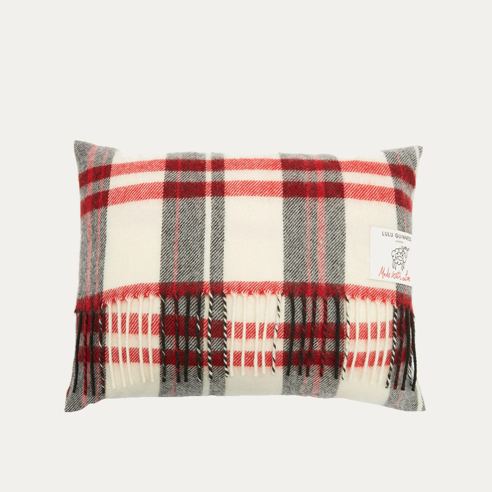 Rectangular cream, red, and grey plaid or tartan cushion with fringe.