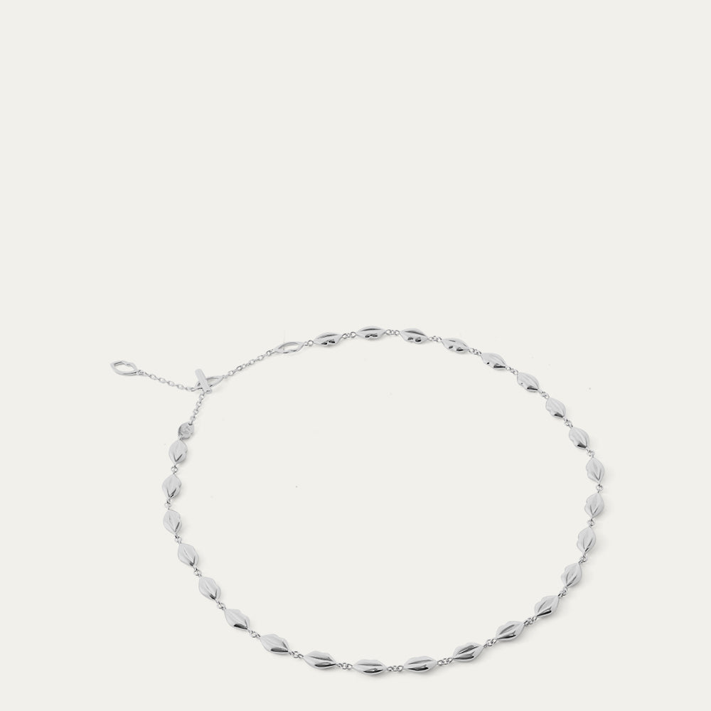 Silver lip chain necklace on a white background