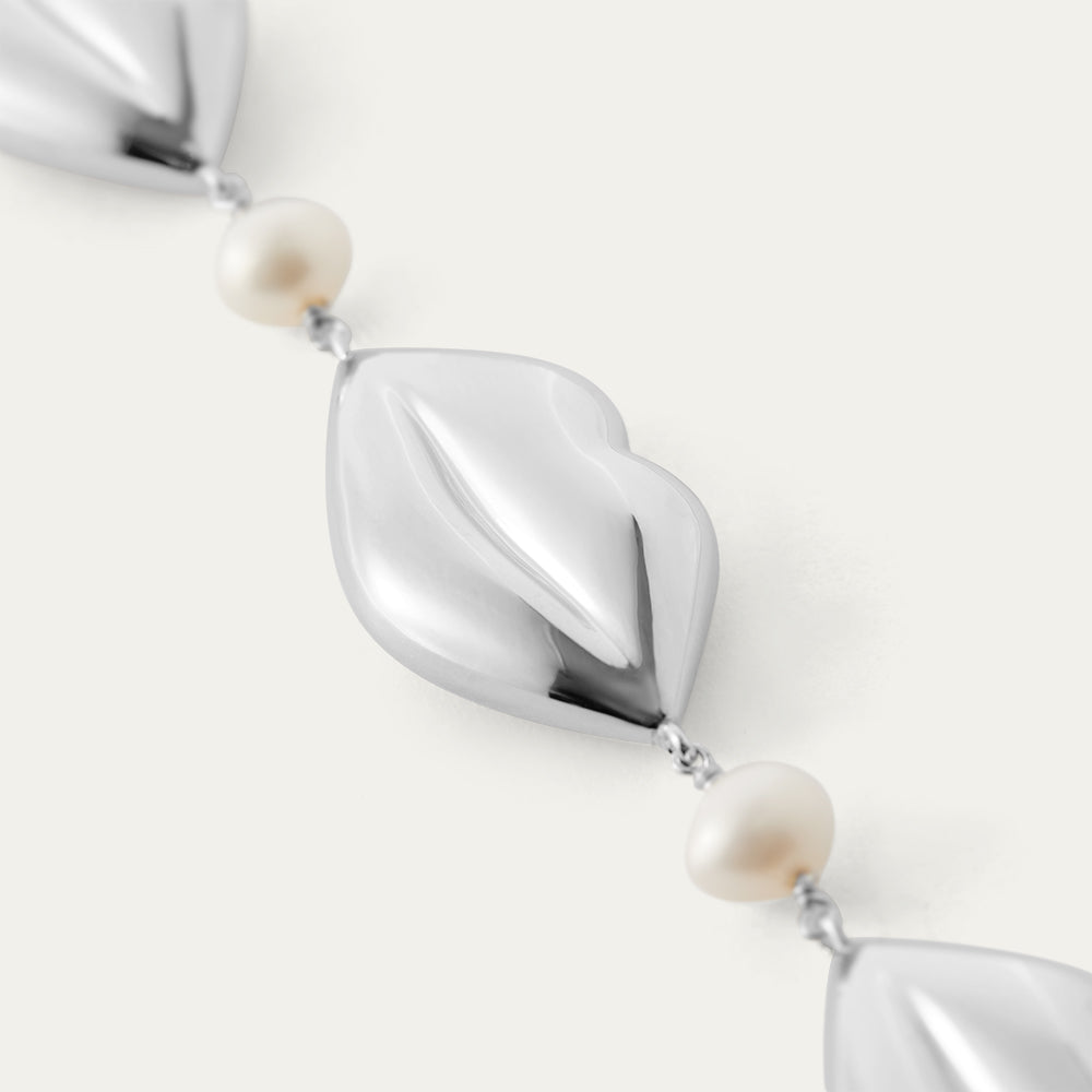 Pearl necklace with silver lip links on a white background
