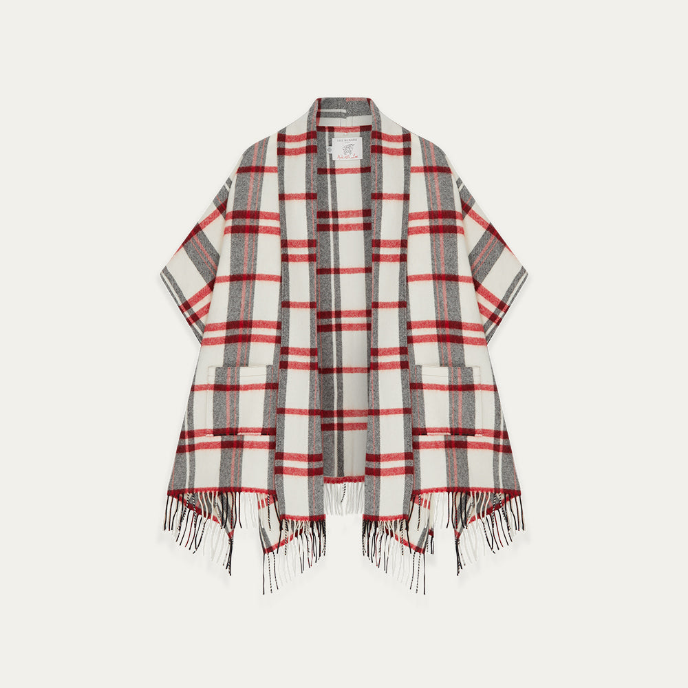 Plaid poncho with red, gray, and white colors on a light gray background