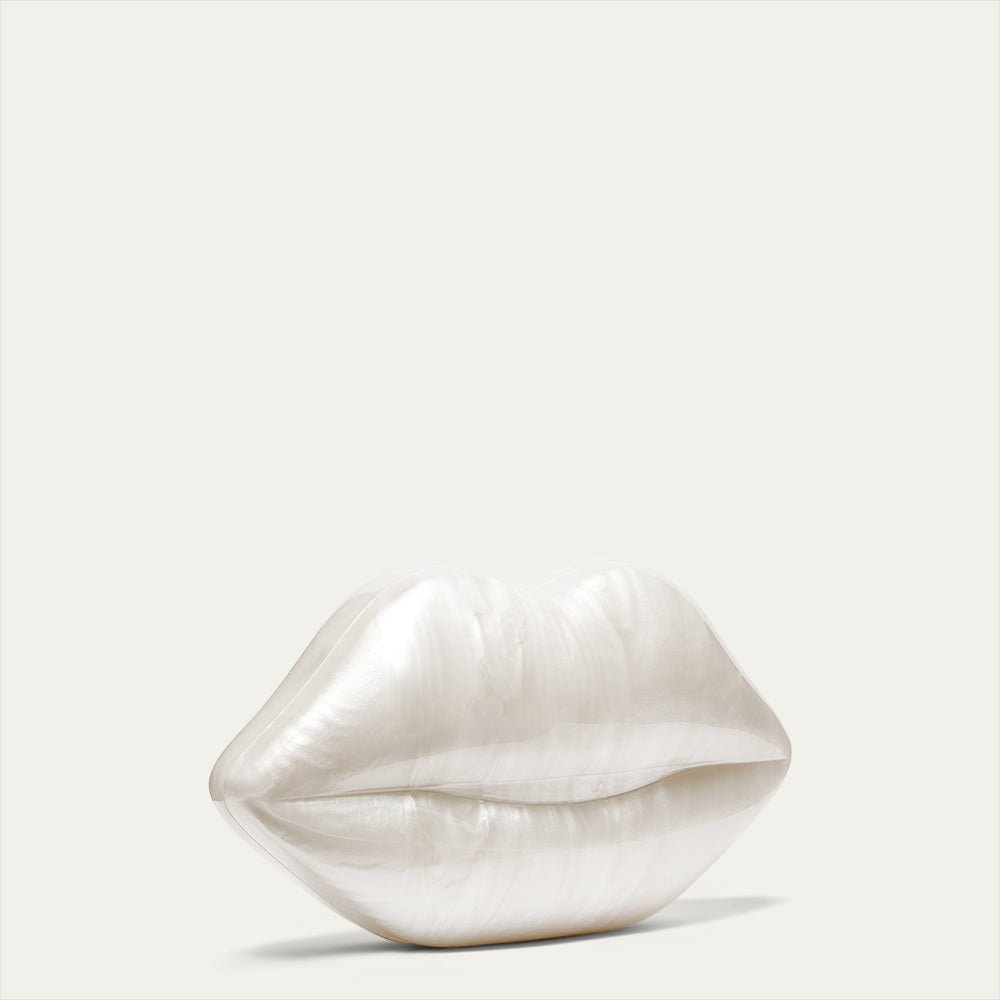 White pearl lip shaped clutch on a light gray background