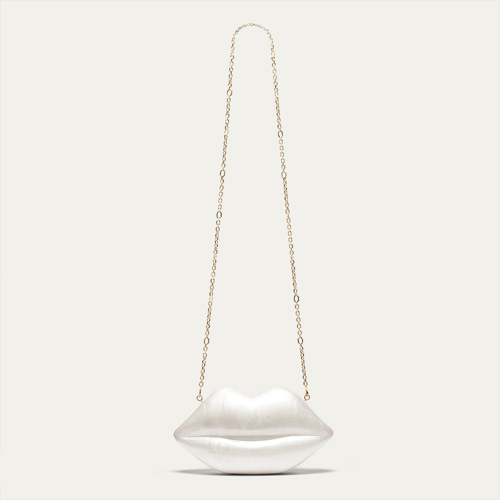 Lip-shaped handbag with a chain strap on a light gray background