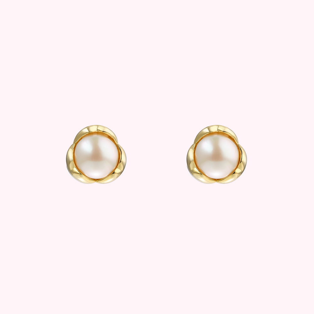 Pair of gold flower-shaped pearl stud earrings.
