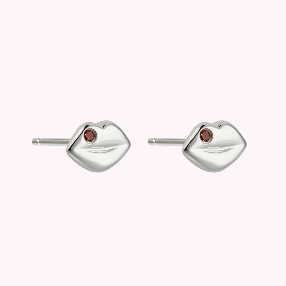 Side image of sterling silver lip shaped stud earring with inset Ruby previous stones.
