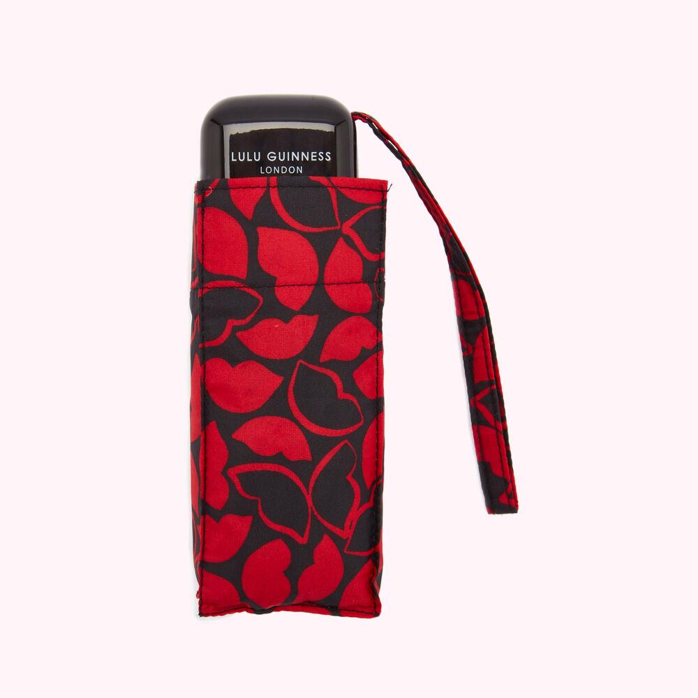 Compact Lulu Guinness London umbrella in red and black lip print.