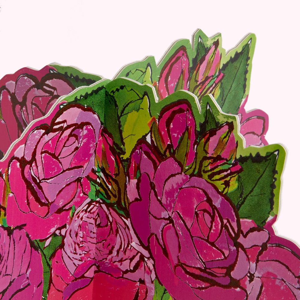 Close-up of a pop-up card featuring a bouquet of pink roses with green leaves, against a white background.