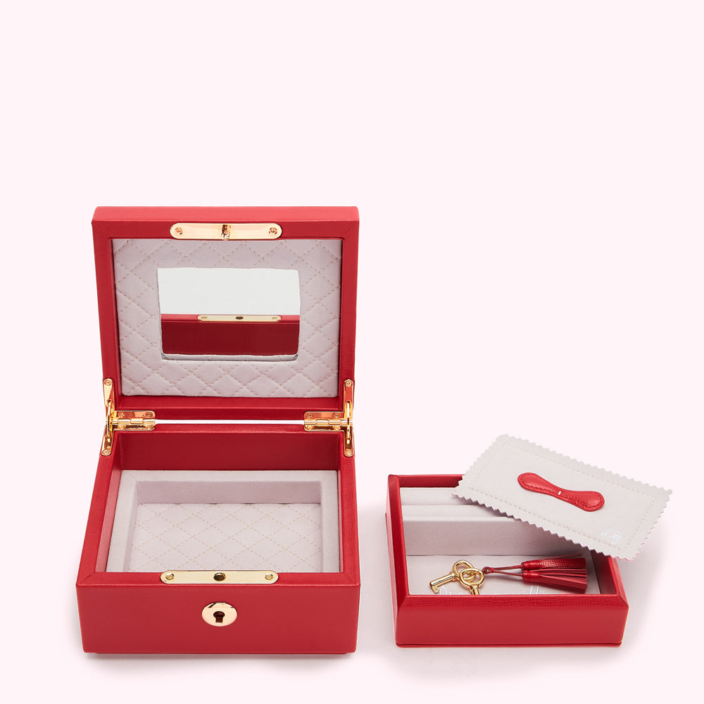 Red leather jewelry box set with a mirror and a smaller box for keys.